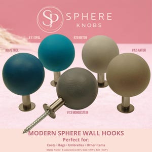 May include: Sphere knobs in shades like petrol, opal, beton, and natur. These matte finish knobs come in three sizes: 6cm, 5cm, and 4cm. The image displays the text "MODERN SPHERE WALL HOOKS".
