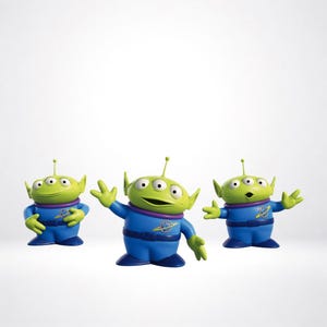 May include: Three green alien figurines with three eyes and pointed ears, wearing blue space suits with purple collars and a yellow planet emblem on the chest. Each figure has a small antenna on its head and dark blue boots, standing in different poses.