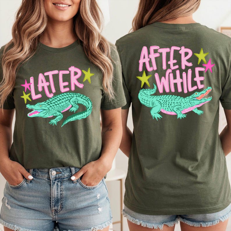 May include: Olive green t-shirt with a teal alligator graphic and the word "LATER" in pink, with yellow stars. The back of the shirt has the words "AFTER WHILE" in pink with a teal alligator and yellow and pink stars.