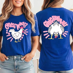 May include: Blue t-shirts with chicken-themed graphics. One shirt features a white chicken with the text "Guess What?" in pink. The other shirt displays a chicken's rear with the words "Chicken Butt" in pink.