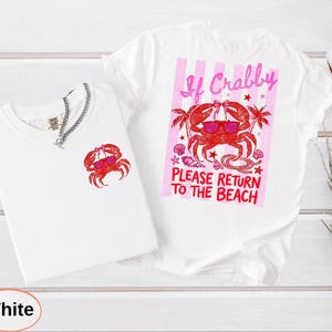 May include: Two white t-shirts with crab graphics. One shirt has a small crab graphic, the other has a larger graphic with text that reads "If Crabby Please Return to the Beach". The crab is wearing sunglasses.
