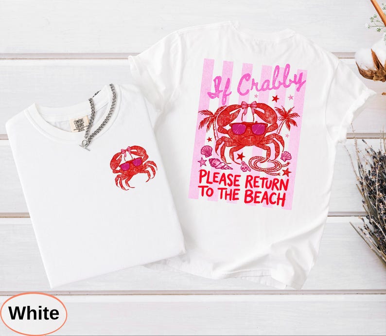 May include: Two white t-shirts with crab graphics. One shirt has a small crab graphic, the other has a larger graphic with text that reads "If Crabby Please Return to the Beach". The crab is wearing sunglasses.
