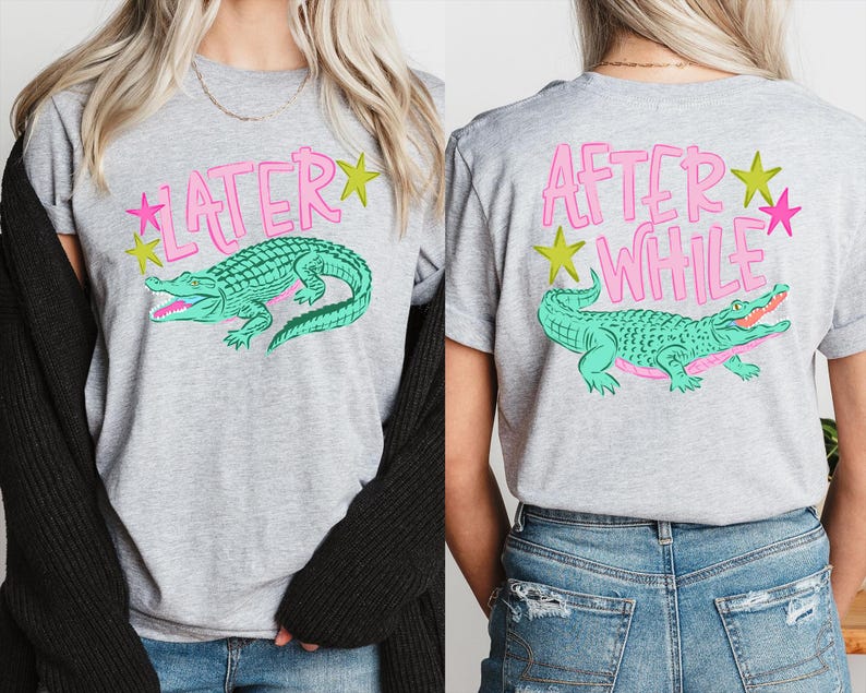 May include: Gray t-shirt with a teal alligator graphic and the text "LATER" on the front and "AFTER WHILE" on the back, with pink and yellow star accents. The shirt is a casual style.