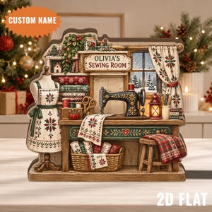 May include: A decorative 2D flat wooden display featuring a sewing room scene with a mannequin, a vintage-style sewing machine, fabric rolls, a basket, and a stool. A sign reads Olivia's Sewing Room, and the design includes festive patterns.