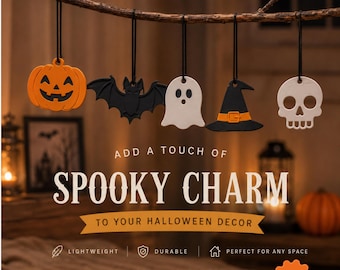 May include: A five-piece set of hanging ornaments featuring a bright orange jack-o'-lantern, a black bat, a white ghost, a black witch hat with an orange band, and a white skull. Each ornament hangs from a black string on a wooden branch.