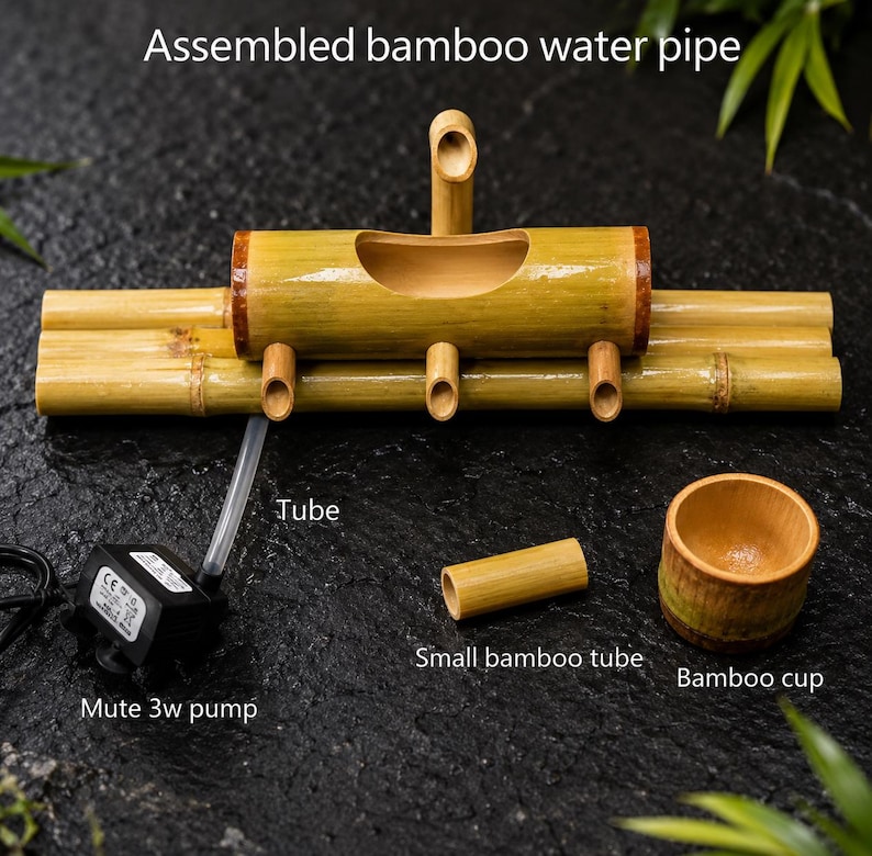 May include: Assembled bamboo water pipe with a mute 3w pump, tube, small bamboo tube, and bamboo cup. The main structure is made of bamboo, featuring a central trough and multiple spouts. The text "Assembled bamboo water pipe" is visible.