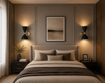 May include: A bedroom featuring a bed with beige and brown bedding, flanked by two dark wood nightstands. Two black hourglass-shaped wall sconces with gold accents provide warm lighting. A framed landscape print hangs above the headboard.