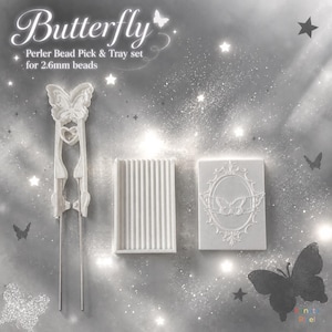 May include: A white Perler bead pick and tray set for 2.6mm beads. The set includes a butterfly-shaped tool with two thin metal prongs, a rectangular tray with vertical ridges, and a rectangular tray featuring an embossed butterfly and frame.