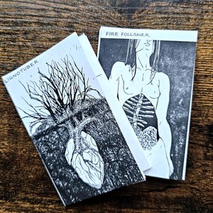 May include: Two black and white art prints. One features a tree with a heart-shaped root system, the text "LIGNOTUBER". The other depicts a figure with exposed internal organs, the text "FIRE FOLLOWER".