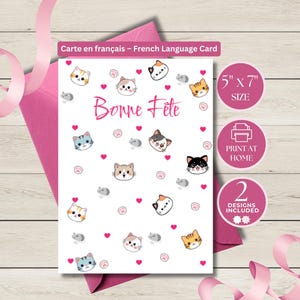 May include: A white greeting card with cartoon cat faces, hearts, and paw prints. The card says "Bonne Fête" in pink script. The card is 5" x 7" and includes two designs. A pink envelope and ribbon are in the background.