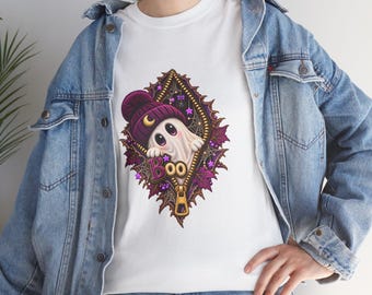 May include: A white t-shirt featuring a graphic of a small white ghost wearing a purple beanie with a crescent moon, peeking out from a gold zipper opening surrounded by purple leaves, spiderwebs, and the word Boo in purple letters.