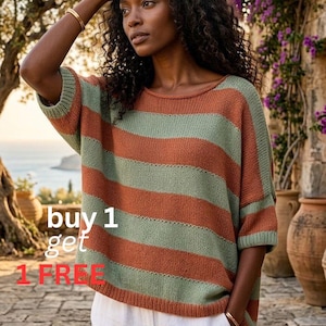 May include: A striped sweater in orange and green with short sleeves. The sweater is worn with white trousers. The image includes the text "buy 1 get 1 FREE".