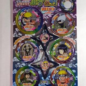May include: A package of Naruto collectible game pieces. The pieces are circular with character illustrations and text. The package has a purple and blue background with Japanese text and star-shaped pieces.