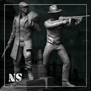 May include: Two grey monochrome miniature figurines depicting figures in 1920s attire. One figure wears a long coat and cap, carrying a sack and pistol. The other wears a fedora and vest, aiming a submachine gun. A lantern sits on a wooden crate.