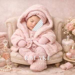 May include: A baby in a pink hooded robe and matching booties sits in a small armchair. The scene is decorated with pink towels, perfume bottles, a pearl necklace, and a bouquet of roses. The overall theme is a spa or relaxation setting.