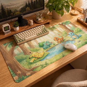 May include: A rectangular desk mat featuring a forest scene with cartoon characters. The mat has a green and brown colour scheme with a river and various characters. A white mouse and a keyboard are on the mat.