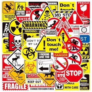 May include: A collection of various warning and safety stickers. The stickers feature bold text and symbols, including "Danger," "Stop," and "Fragile." Colors include red, yellow, black, and white. Some stickers have images of a skull, a cat, and a moose.