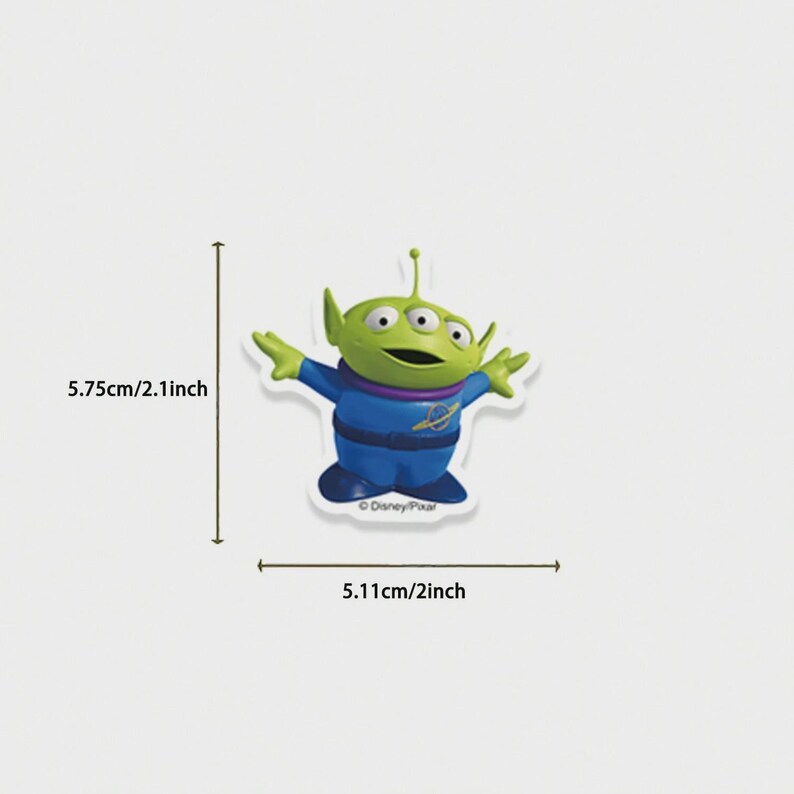 May include: A green alien character with three eyes, wearing a blue uniform with a purple collar. The character is 2.1 inches tall and 2 inches wide. The Disney/Pixar logo is visible. The image is on a white background.