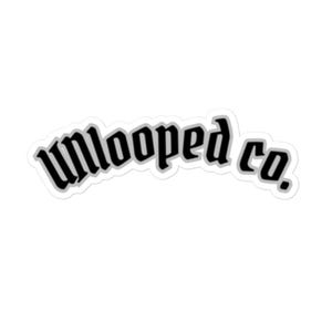 May include: A white sticker featuring the words "unlooped co." in a black, gothic-style font. The text is outlined in a thin, light grey border, creating a subtle contrast against the white background. The sticker has a slightly curved shape.