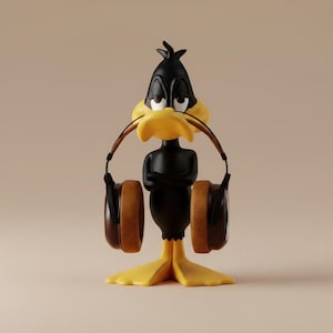 May include: A black Daffy Duck figurine with a yellow beak and feet, wearing brown headphones. The cartoon character has its arms crossed and a slightly annoyed expression. The background is a solid beige color.
