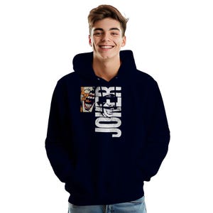 May include: Navy blue hoodie featuring a graphic of the Joker. The design includes the word "JOKER" in white, vertically aligned, with a smiling face graphic. A smaller image of the Joker laughing is on the left side.