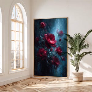 May include: Large framed artwork depicting red roses against a dark blue backdrop. The painting has a textured, painterly style, with the roses in full bloom. The artwork is displayed in a bright room with a large window and a potted plant.