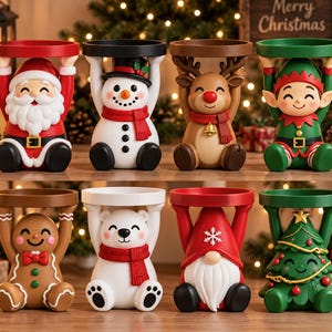 May include: A set of eight decorative Christmas-themed figurine stands, each featuring a character holding a circular platform above their head. Characters include Santa, a snowman, a reindeer, an elf, a gingerbread person, a polar bear, a gnome, and a tree.