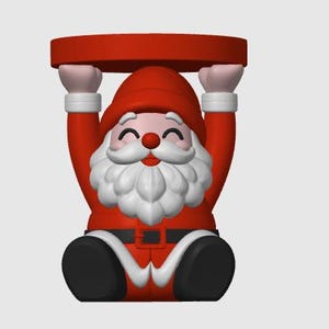 May include: A Santa Claus figurine wearing a red suit with a white trim, a black belt, and black boots. The figure has a white beard, a red hat, and is holding a flat, circular red platform above its head with both hands in a raised position.