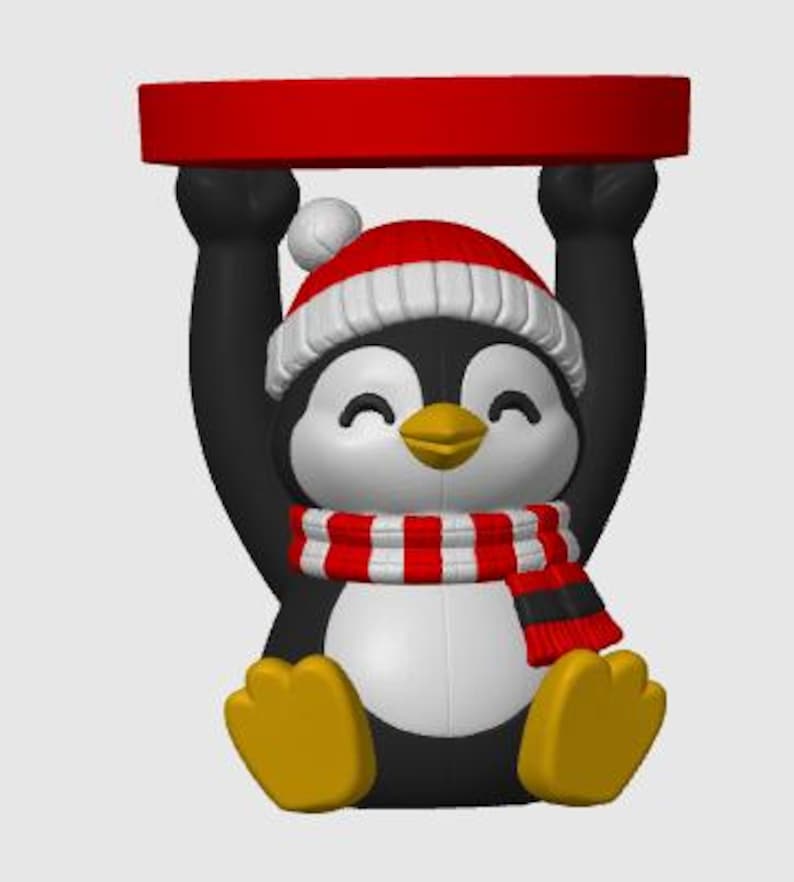 May include: A decorative penguin figurine featuring a black and white body, yellow feet, and a yellow beak. The penguin wears a red and white winter hat with a pom-pom and a red and white striped scarf, while holding a red circular tray overhead.