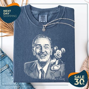 a blue t-shirt with a drawing of a man and a Mickey Mouse, along with a price tag and a sale promotion.