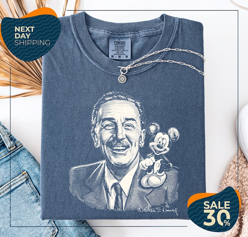 a blue t-shirt with a drawing of a man and a Mickey Mouse, along with a price tag and a sale promotion.
