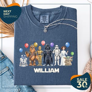 a blue t-shirt with a graphic design of various Star Wars characters, including Chewbacca, Darth Vader, and the rest of the iconic characters, along with colorful balloons. The t-shirt is displayed on a white background, and there are two sale signs indicating a 30% discount on the item.