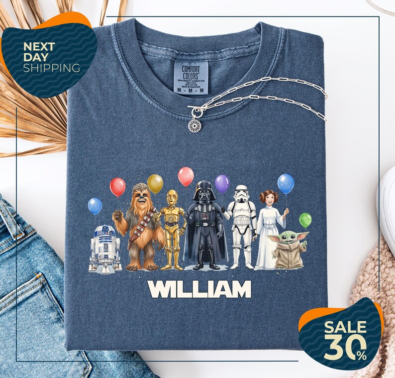 a blue t-shirt with a graphic design of various Star Wars characters, including Chewbacca, Darth Vader, and the rest of the iconic characters, along with colorful balloons. The t-shirt is displayed on a white background, and there are two sale signs indicating a 30% discount on the item.