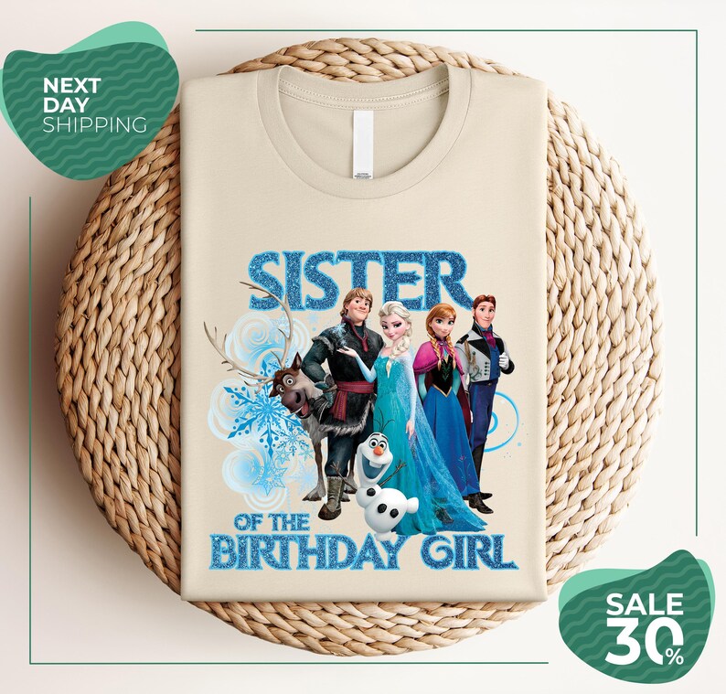 A t-shirt with a design featuring characters from the Disney movie Frozen, specifically the sisters Elsa and Anna, along with the text "SISTER OF THE BIRTHDAY GIRL".