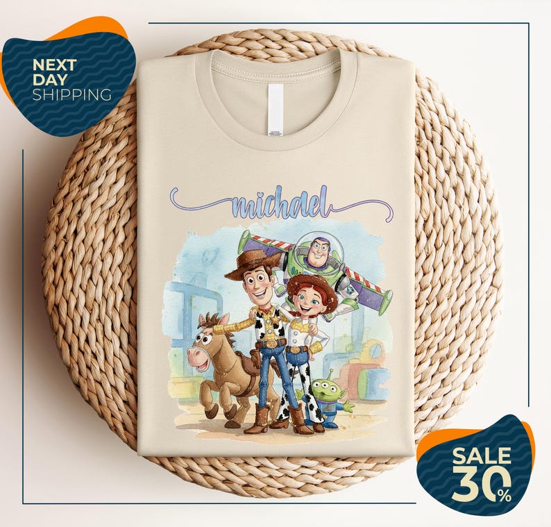 a t-shirt with a cartoon illustration of characters from the Toy Story franchise, including Woody, Buzz Lightyear, and a girl. The t-shirt is displayed on a woven basket, and there are two sale signs indicating a 30% discount on the item.