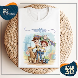 a white t-shirt with a cartoon illustration of characters from the Toy Story franchise, including Woody, Buzz Lightyear, and a horse. The t-shirt is displayed on a woven placemat, and there are two sale signs indicating a 30% discount on the item.