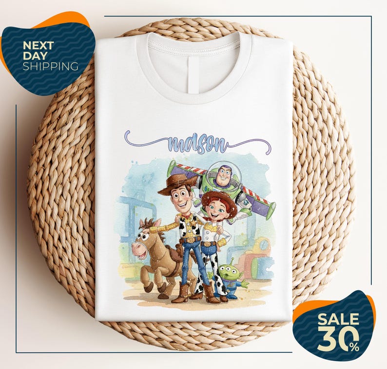 a white t-shirt with a cartoon illustration of characters from the Toy Story franchise, including Woody, Buzz Lightyear, and a horse. The t-shirt is displayed on a woven placemat, and there are two sale signs indicating a 30% discount on the item.