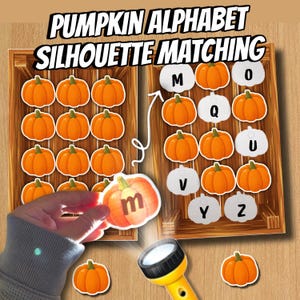 May include: A Pumpkin Alphabet Silhouette Matching educational activity set featuring orange pumpkin cutouts and white pumpkin-shaped cards with black letters. The text PUMPKIN ALPHABET SILHOUETTE MATCHING is displayed at the top of the wooden crate design.