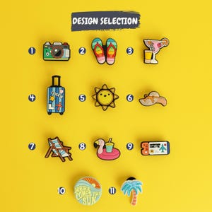May include: A collection of eleven colorful shoe charms arranged in a grid on a yellow background, labeled with numbers one through eleven. The designs include a camera, flip-flops, a cocktail, a suitcase, a sun, a hat, a chair, a flamingo float, a ticket, a circular badge with the text HERE COMES THE SUN, and a palm tree.