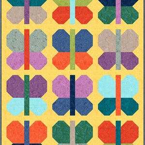 May include: A quilt featuring a grid of twelve butterfly shapes on a yellow background. Each butterfly is composed of four wings in various colors including teal, red, green, purple, and blue, with a vertical rectangular body in a contrasting color.