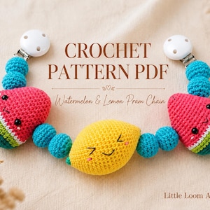 May include: A crochet pattern PDF for a watermelon and lemon pram chain by Little Loom Atelier. The chain features two crocheted watermelon slices and a central lemon, all with embroidered faces, connected by bright blue beads and white clips.