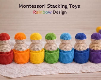 May include: A set of seven crochet stacking toys in a rainbow design. Each toy is a different color, including red, orange, yellow, green, blue, indigo, and violet. The toys are arranged on a white cloth. The text "Montessori Stacking Toys Rainbow Design" is at the top.