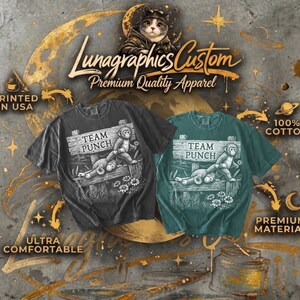 May include: Two t-shirts, one charcoal and one teal, with a graphic of a monkey on a sign saying "TEAM PUNCH". The shirts are labelled "Ultra Comfortable", "100% Cotton", and "Premium Material". The text "Lunagraphics Custom Premium Quality Apparel" is also visible.