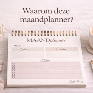 May include: A cream-coloured spiral-bound planner with gold detailing, labelled "MAANDplanner". The image also shows a coffee cup, a pen, and a small vase with flowers. The text "Soft Focus" is visible.