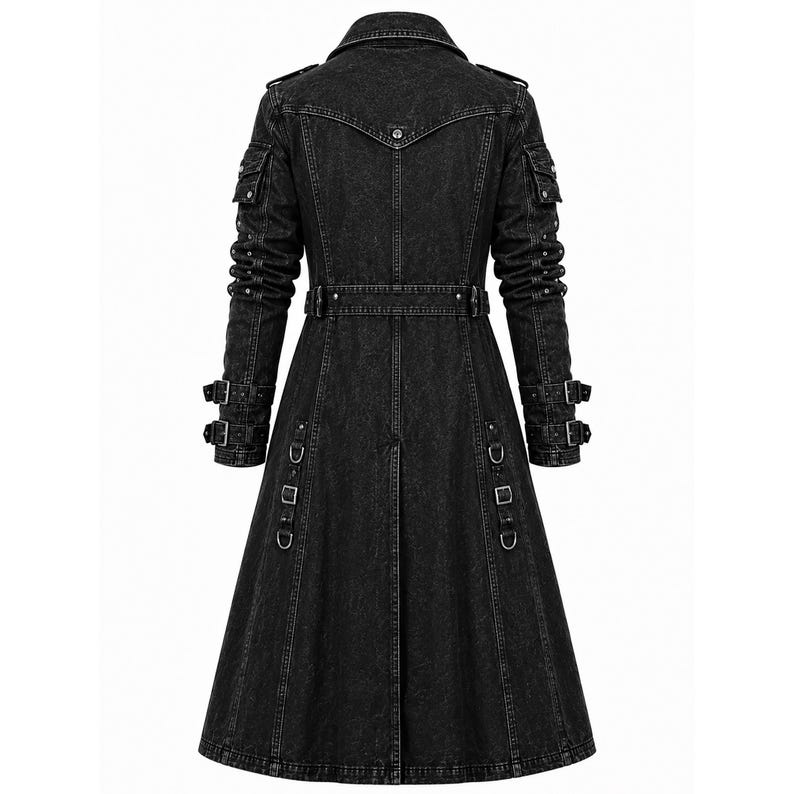 May include: A long, black denim coat featuring a structured collar, shoulder epaulets, and long sleeves with dual buckle straps at the cuffs. The coat includes a belted waist, multiple utility pockets on the upper arms, and vertical metal D-ring accents.
