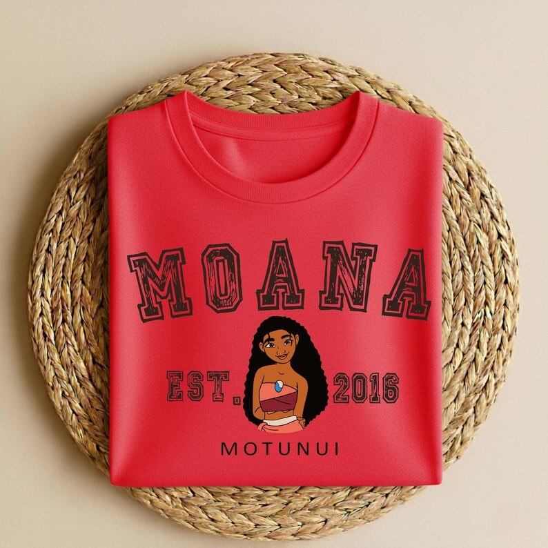 May include: A white ceramic mug with a black handle and the text "But First, Coffee" in a bold, black font. The mug is on a wooden surface. The mug is approximately 10 cm tall.