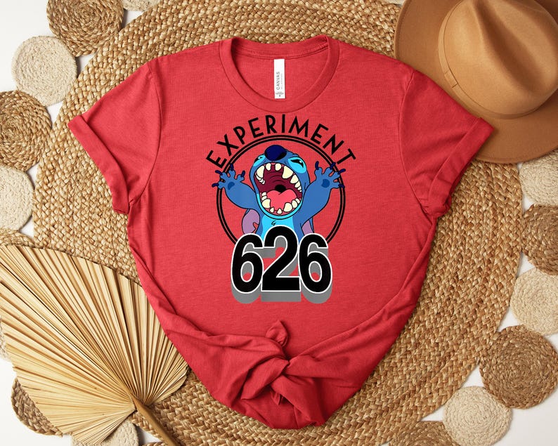 May include: Red t-shirt with a graphic of the character Stitch from Lilo & Stitch. The design includes the text "EXPERIMENT" in a circle around Stitch, with the number "626" below. The shirt is made of a soft material.