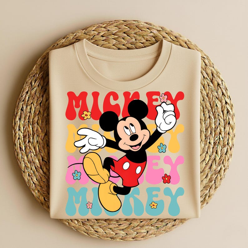 May include: A white ceramic mug with a black handle and the text "But First, Coffee" in a bold, black font. The mug is filled with a dark liquid, likely coffee, and sits on a light-colored surface.