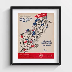 May include: Framed vintage Los Angeles Dodgers baseball poster. The poster features cartoon illustrations of baseball players climbing a mountain, with the text "And they said Mount Everest was TOUGH!!" and "Los Angeles Dodgers".