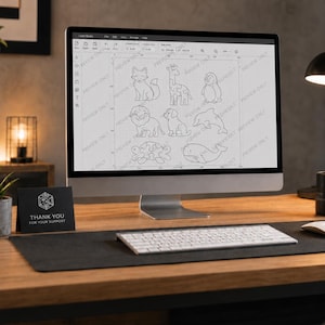May include: A computer monitor displays a laser cutting design of various animals, including a fox, giraffe, penguin, lion, dog, dolphin, turtle, and whale. A keyboard and mouse sit on a desk. A card reads "THANK YOU FOR YOUR SUPPORT."